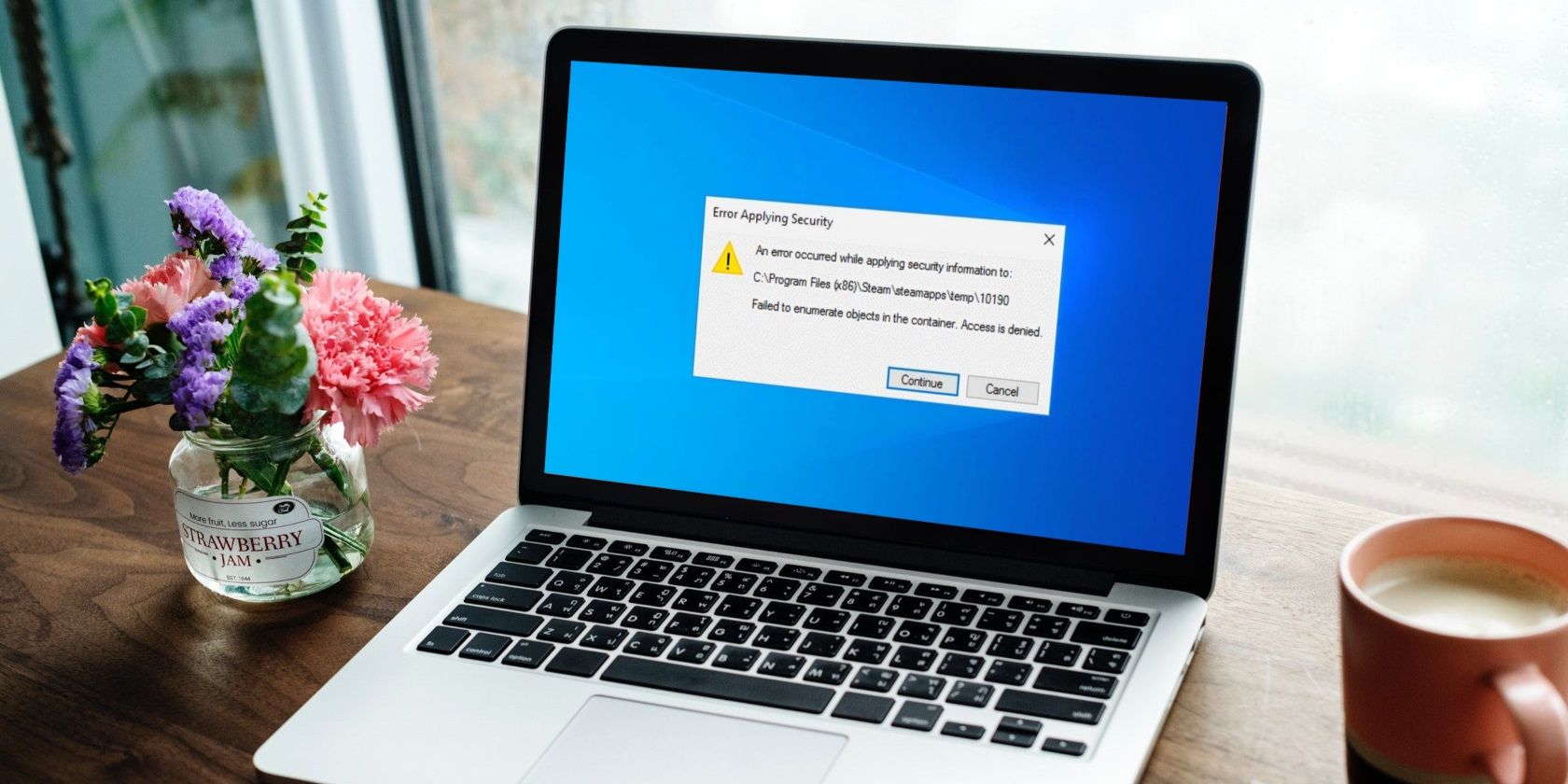 a windows laptop on a wooden table with coffee and floral port